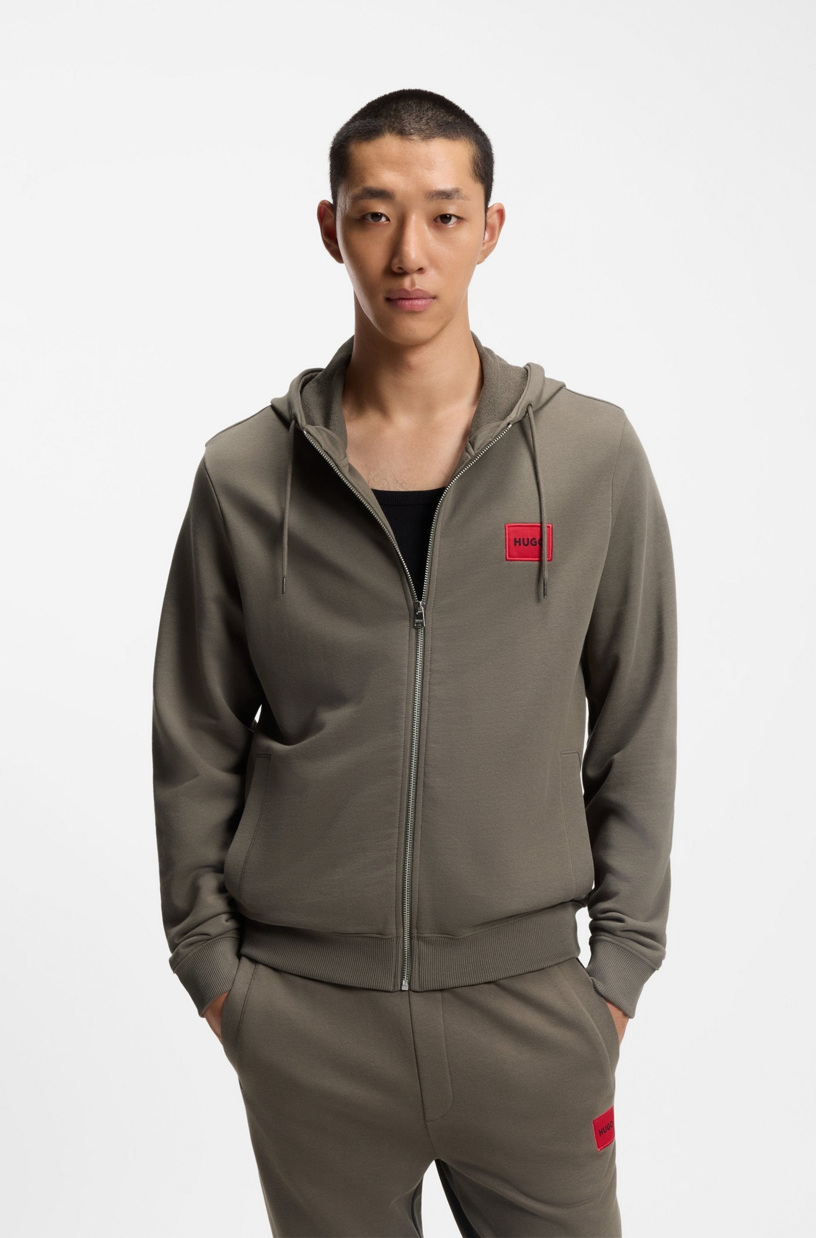 Prenda con capucha de felpa de algodón con cremallera y etiqueta con logo